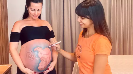 Mulher grávida segura brinquedo em pré-natal